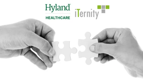 Two hands putting puzzle pieces together, with the Hyland Healthcare and iTernity logos above