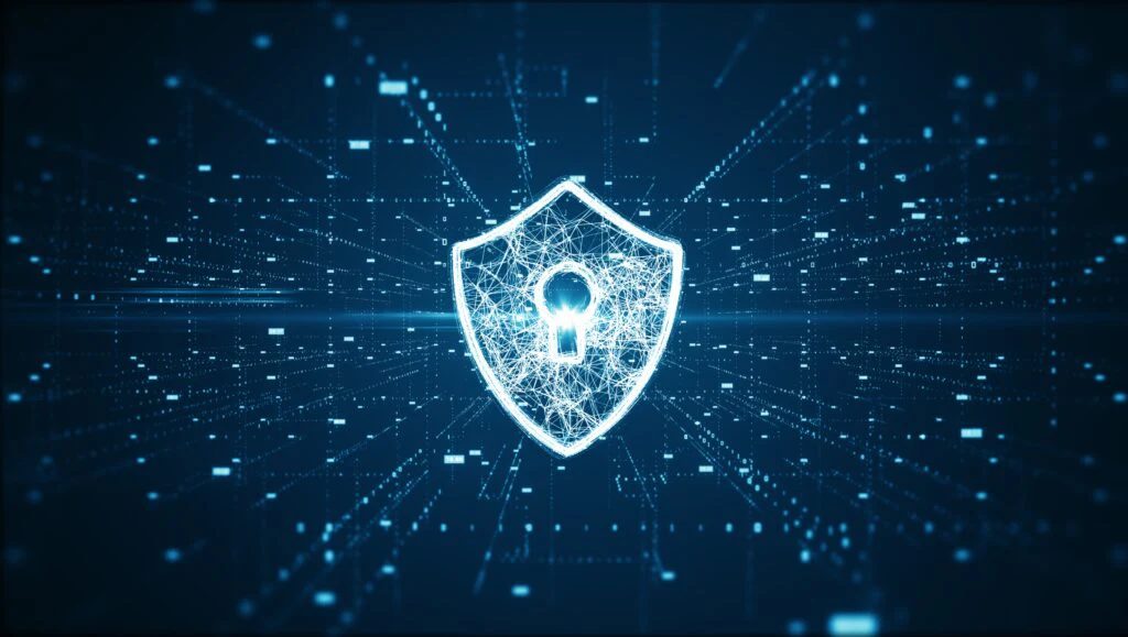 Protective shield with a keyhole in front of a blue data grid as a symbol for IT security