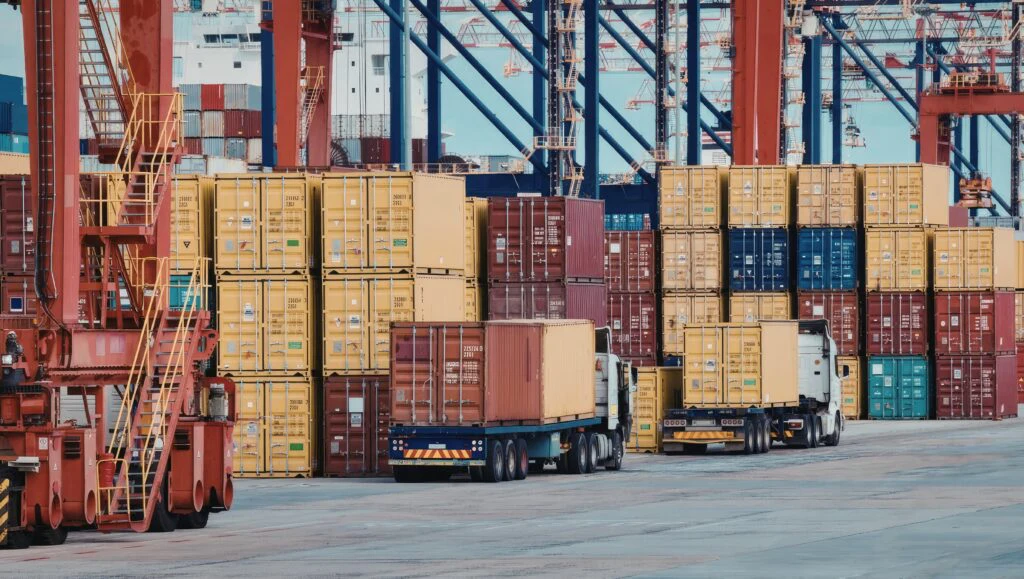 Container terminal with stacked containers, trucks, and loading cranes